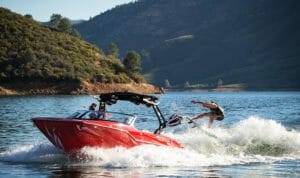 Red Supreme ZS232 wake surfing across lake
